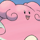 Blissey, a happy, pink Pokémon, smiles atop an evening sky background.